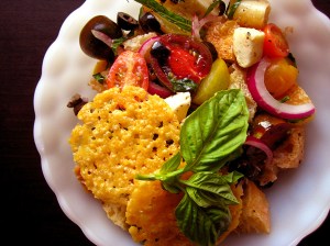panzanella salad with crispy rounds of parmesan cheese